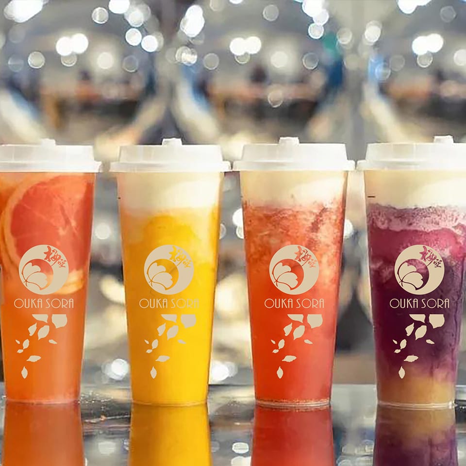 Four colorful drinks in Ouka Sora cups.