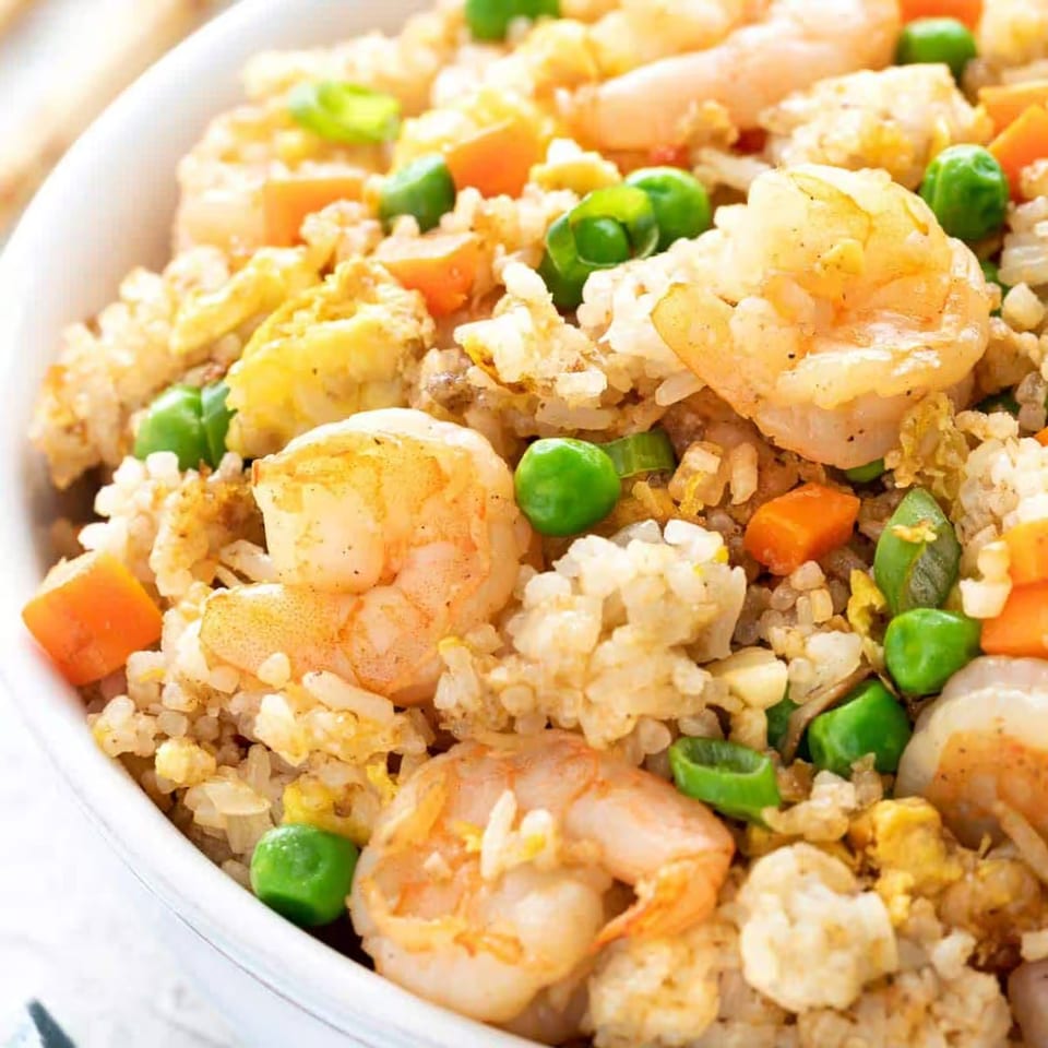 Shrimp fried rice with peas, carrots, and egg.